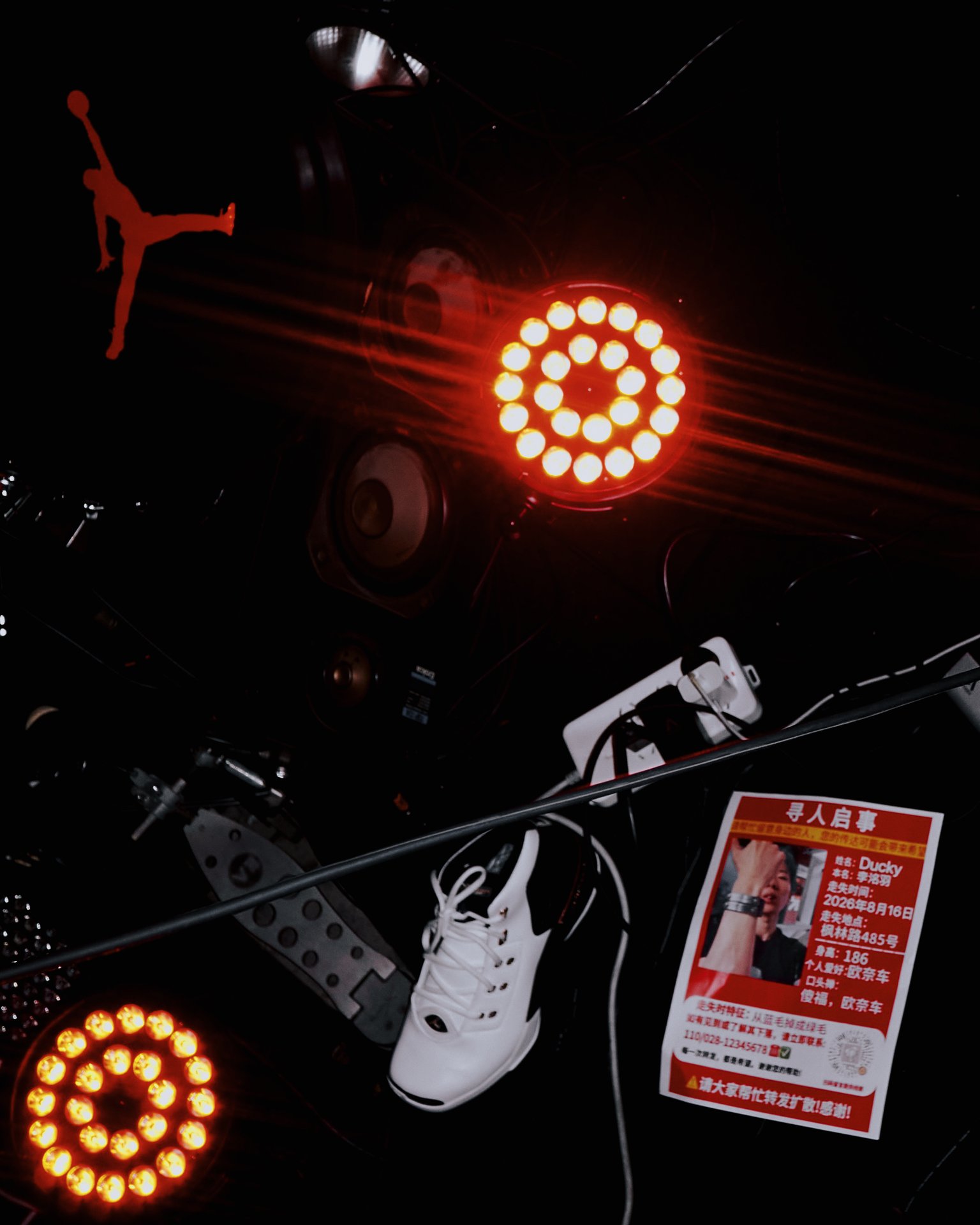 Red Jumpman silhouette, glowing speaker lights and a missing-person flyer for Ducky