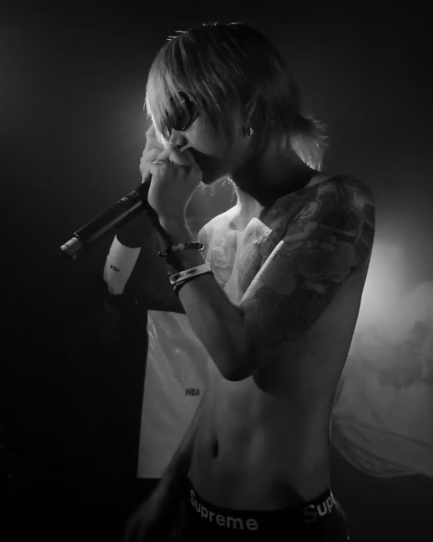 Artist performing live in black and white
