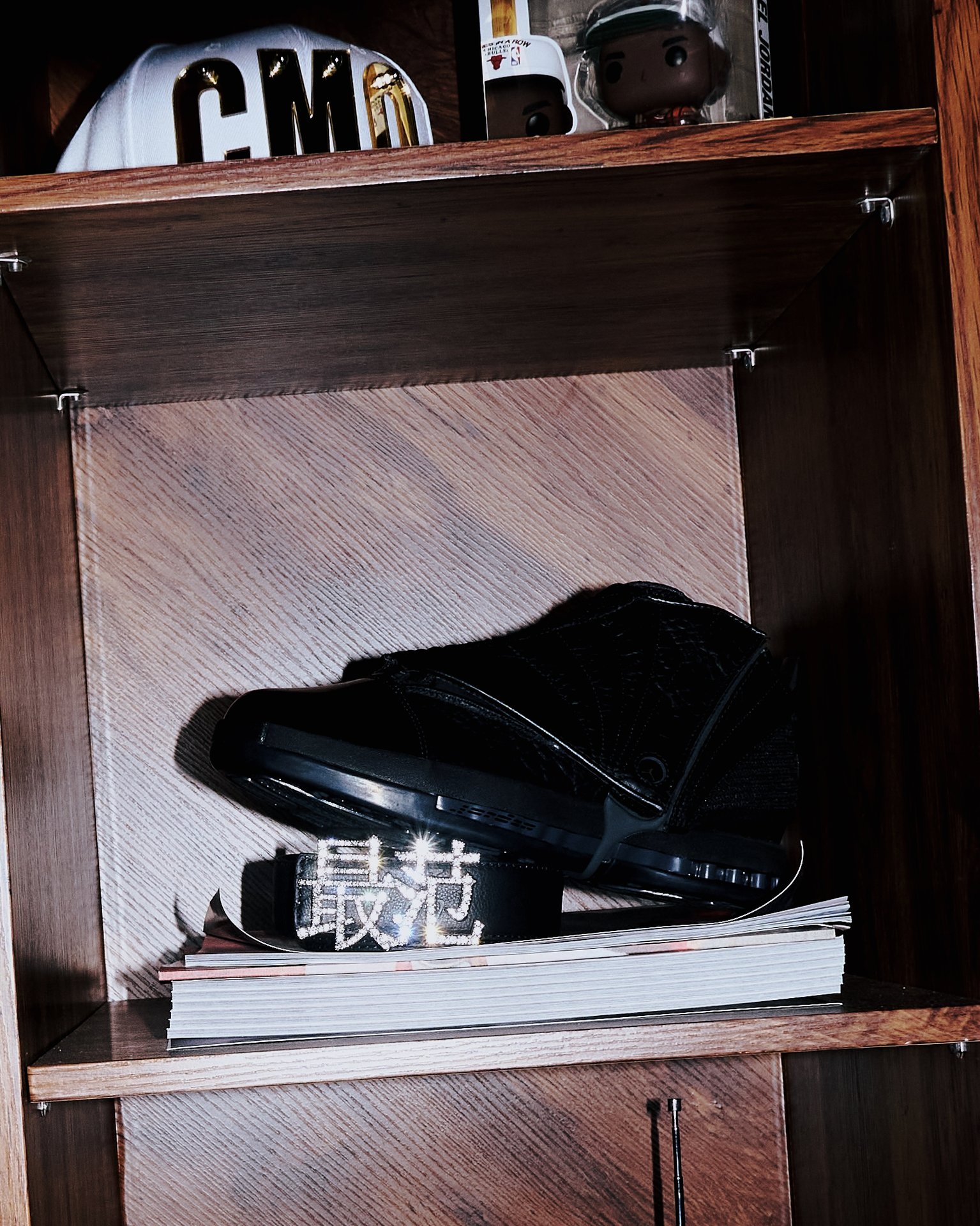 Black Jordan shoe and Human Register belt on an archive shelf