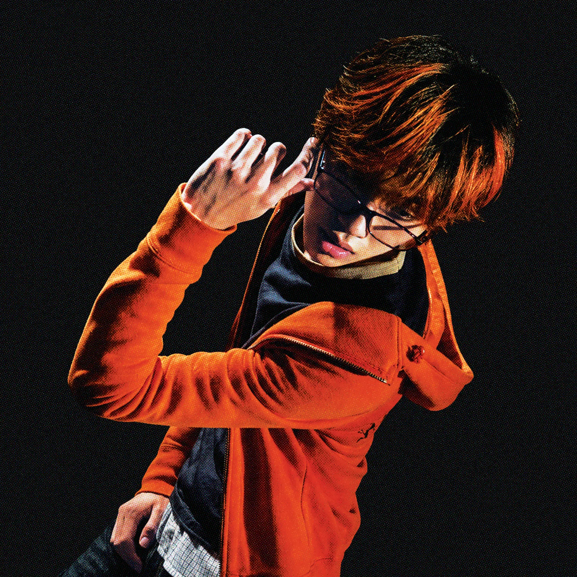 rubenmccarter in an orange jacket adjusting his glasses