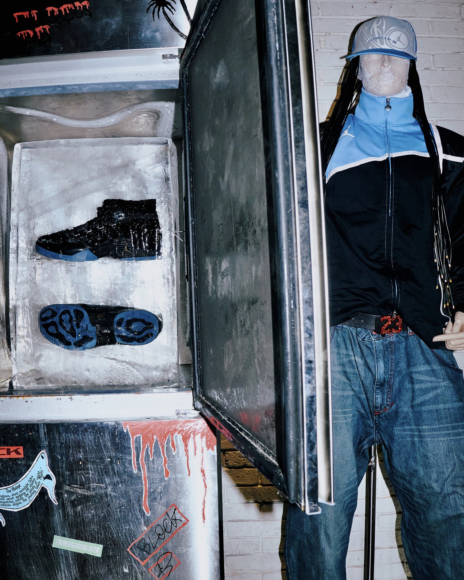 Air Jordan shoes frozen in ice beside a dressed mannequin